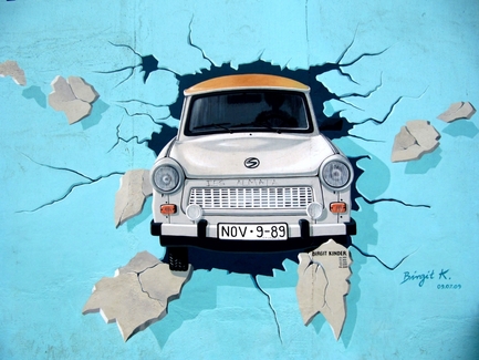 Berlin Wall Street Art Mural Graffiti with Trabi Car. A quintessential thing to do in Berlin