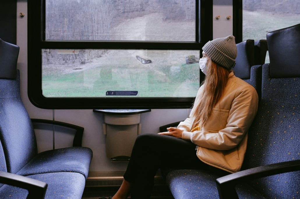 Covid backpacking - riding a train wearing a mask during the Corona pandemic.