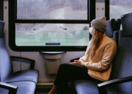 Covid backpacking - riding a train wearing a mask during the Corona pandemic.