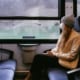 Covid backpacking - riding a train wearing a mask during the Corona pandemic.