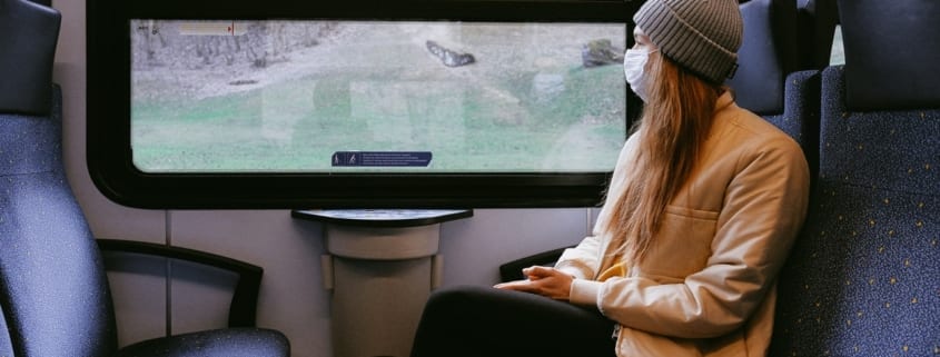 Covid backpacking - riding a train wearing a mask during the Corona pandemic.