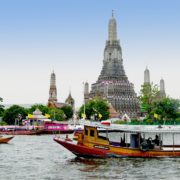 Take a boat tour on the with Wat Arun in the background