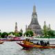 Take a boat tour on the with Wat Arun in the background