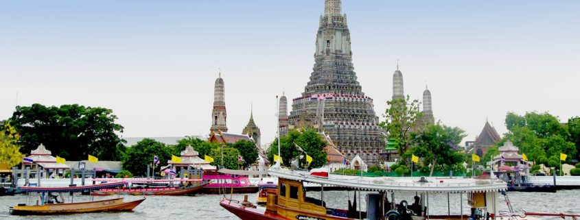 Take a boat tour on the with Wat Arun in the background