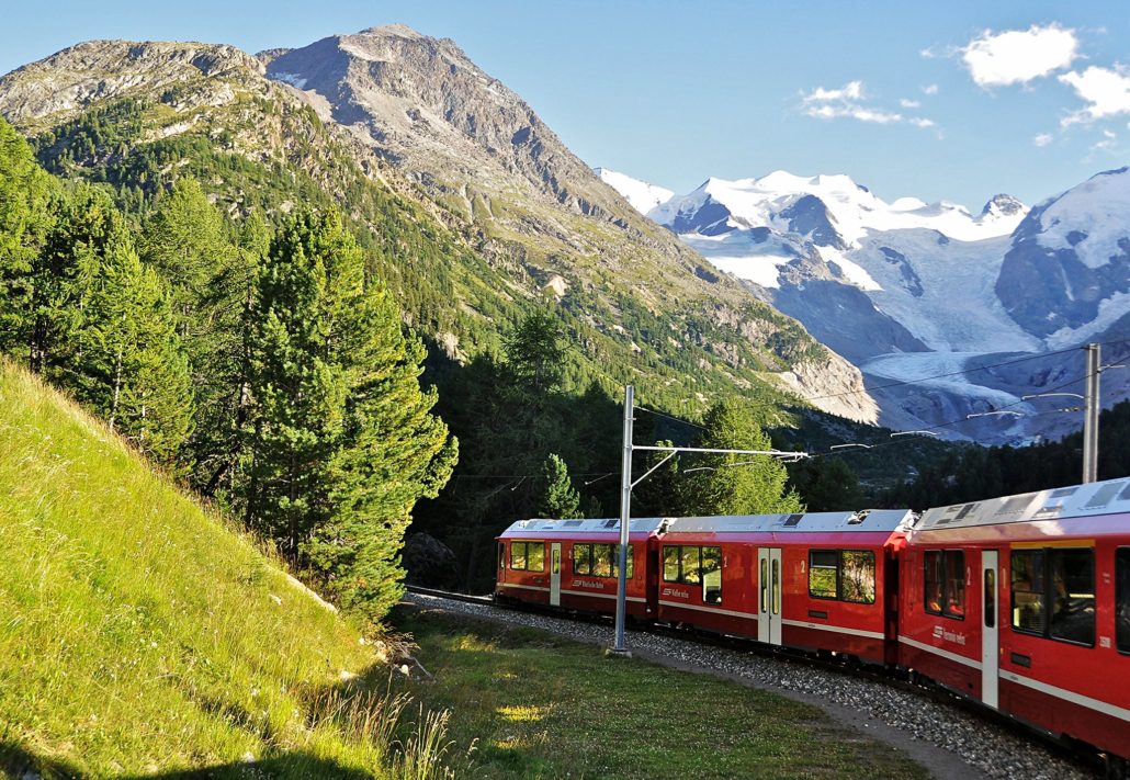 Bernina Line train descending through the famous Montebello curve towards Pontresina, with the Morteratsch Glacier in the background (Canton Graubünden, Switzerland).